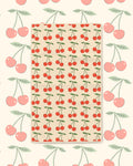 Cherry Lover Kitchen & Tea Towel with red cherries and green leaves in rows on a cream background
