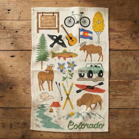 Colorful tea towel with icons of Colorado's nature, wildlife, and outdoor activities, featuring mountains, trees, and a welcome sign.