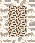 Cosmic Creatures Kitchen & Tea Towel with swans, prowling animals, moths and crescent moons in black and gold on cream