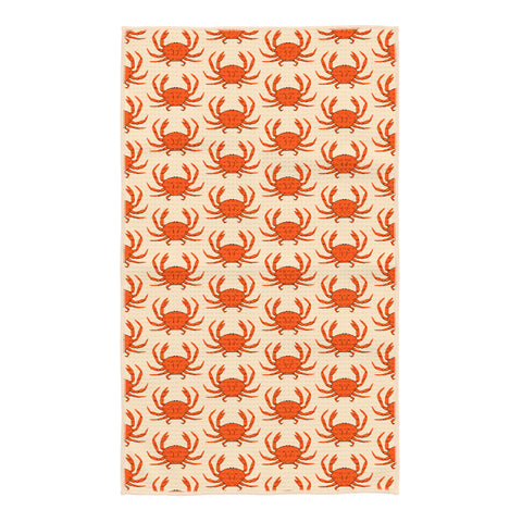 Kitchen tea towel with orange crab pattern on cream waffle-weave fabric, large crabs scattered across the towel with a