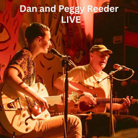 Dan and Peggy Reeder performing live music on stage with guitars, creating an engaging atmosphere.
