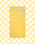 Desert Dreams Wander & Travel Towel in yellow and cream checkerboard print, laid flat on a pale yellow checked background.