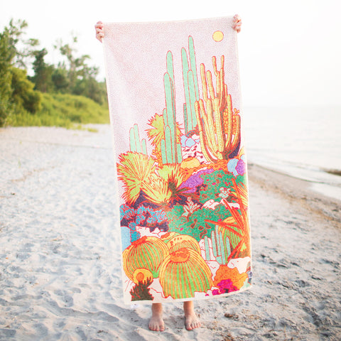 Desert Dreams Wander Towel with vibrant cacti design, made from recycled materials, weighs 8oz, includes travel pouch. Trek Light.