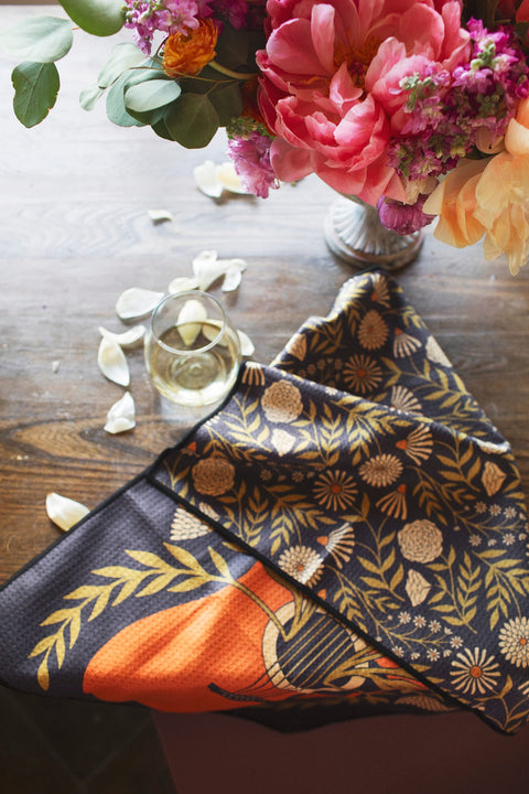 Dinner Music Kitchen & Tea Towel featuring floral design and guitar motif on a wooden table with flowers.