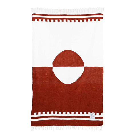 Trek Light Divided Sky Blanket in rust and white, handwoven from recycled materials, featuring unique geometric design.