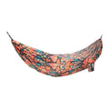 Colorful Trek Light hammock with vibrant leaf pattern, perfect for outdoor relaxation and travel adventures.