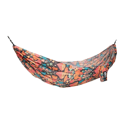 Colorful Trek Light hammock with vibrant leaf pattern, perfect for outdoor relaxation and travel adventures.