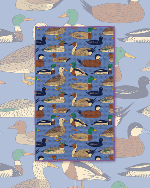 Ducks In A Row Kitchen & Tea Towel with mallards and other ducks in rows on a blue background