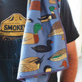 Ducks In A Row Kitchen & Tea Towel featuring colorful duck illustrations on a vibrant blue background.