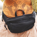 Everyday Fanny Pack (Eclipse) worn around the waist with waterproof zippers and multiple pockets for versatile use and comfort.