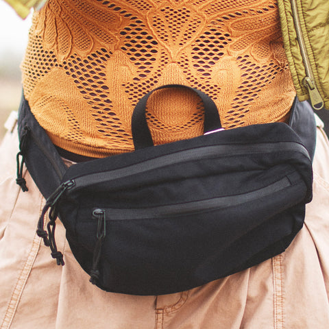 Everyday Fanny Pack (Eclipse) worn around the waist with waterproof zippers and multiple pockets for versatile use and comfort.