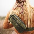 Person wearing Everyday Fanny Pack (Fern) crossbody in a outdoor setting, showcasing versatility and style.