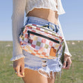 Woman wearing checkered fanny pack as a hip pack outdoors, showcasing versatility as a waist or shoulder sling bag.