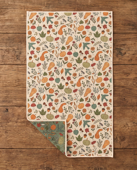Fall Harvest waffle kitchen tea towel flat lay with a corner folded up to reveal the reverse print