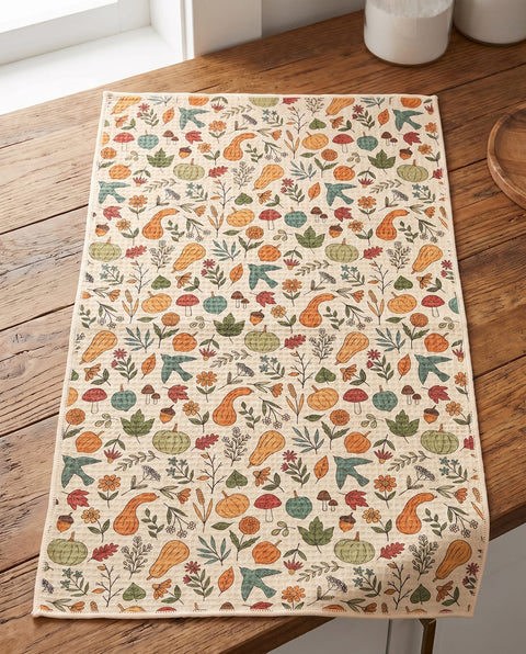 Fall Harvest waffle kitchen tea towel laid flat on a wood counter showing the full front print