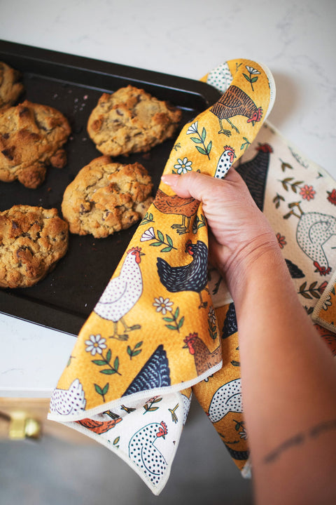 Farmhouse Chicken Kitchen & Tea Towel being used to grab cookies from a baking tray, featuring colorful chicken designs.