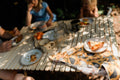 Farmhouse Chicken Kitchen & Tea Towel resting on a table during a family meal outdoors.