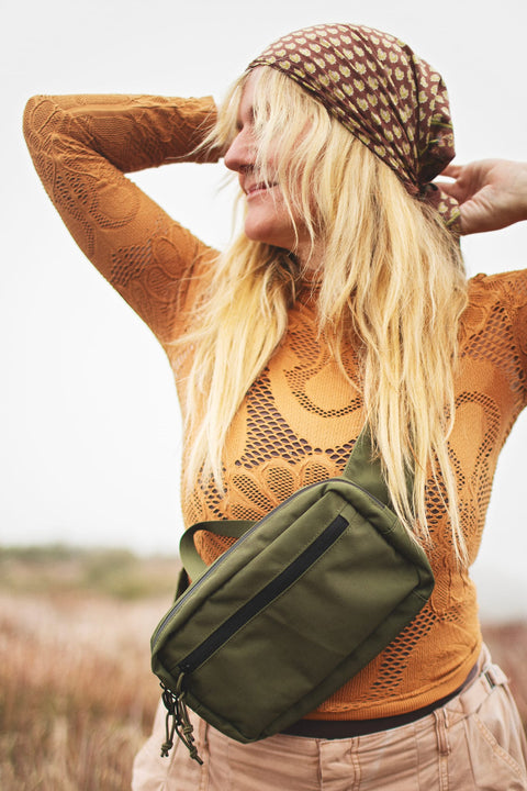 Everyday Fanny Pack (Fern) worn by a woman in a stylish outfit outdoors, showcasing its functional design.