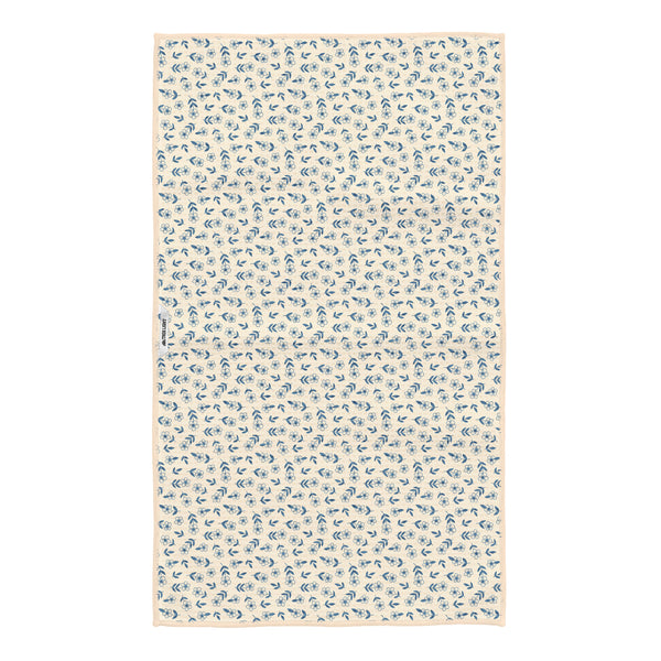 Reverse side of the Floral Trout kitchen tea towel showing a scattered blue flower and leaf pattern with a hanging loop and