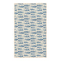 Beige kitchen tea towel covered in blue floral trout fish arranged in rows with small white flowers between them