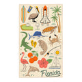 Florida Kitchen & Tea Towel with vibrant Florida-themed illustrations of wildlife, surfboard, and NASA shuttle.