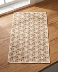 Ghost Garden kitchen tea towel laid flat on a wood counter showing the full cream front print