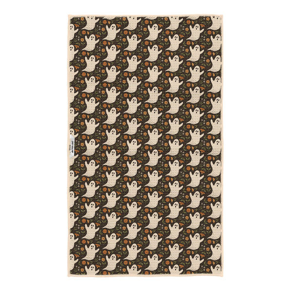 Reverse side of Ghost Garden tea towel on dark brown with cream ghosts, orange flowers and Trek Light woven tag