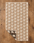 Ghost Garden kitchen tea towel flat lay with a corner folded up to reveal the dark reverse print