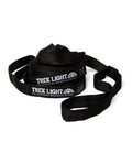 Black Go Anywhere Pro Hammock Straps, coiled with looped ends and woven webbing, with white Trek Light labels, on white.