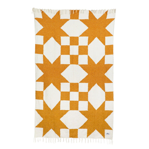 Beautiful handwoven Goldie blanket made from recycled clothing materials, featuring a cozy geometric design with versatile charm. By Trek Light.