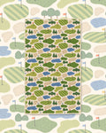 Golf Dreams Kitchen & Tea Towel with a golf course pattern of green fairways, ponds and trees