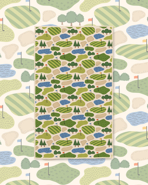 Golf Dreams Kitchen & Tea Towel with a golf course pattern of green fairways, ponds and trees