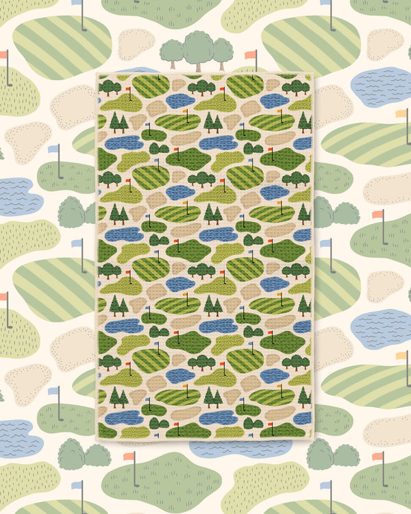 Golf Dreams Kitchen & Tea Towel with a golf course pattern of green fairways, ponds and trees