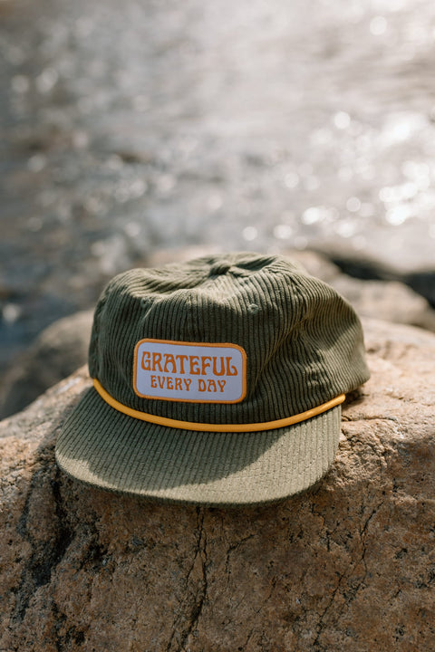 Grateful Every Day hat by Trek Light, flat brim snapback in cotton corduroy, stylish unisex accessory for daily gratitude expression.
