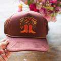 Hand holding the Grow Your Own Way Hat featuring floral design and boots, perfect for stylish comfort.