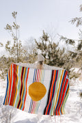 Person holding colorful Halley's Comet Blanket by Trek Light in snowy outdoors