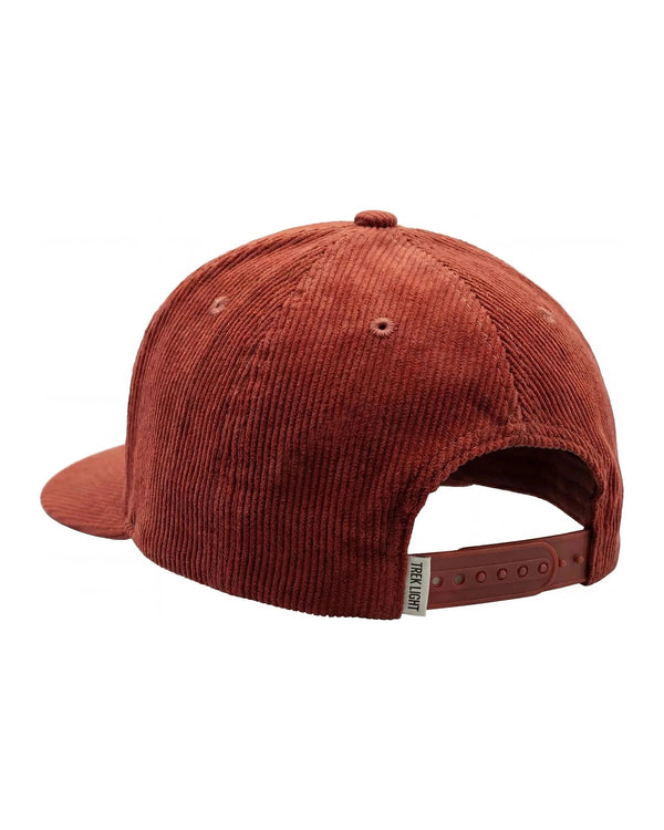 Back view of the Happiest Camper Hat in rust red corduroy with a snap strap and small woven tag, on white.