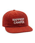 Happiest Camper Hat in rust red corduroy with white stitched "HAPPIEST CAMPER" lettering on the front, on white.