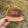 Trek Light Happiest Camper Hat in brown corduroy with sunflowers; 6-panel snapback for comfortable outdoor adventures.