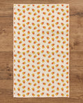Happy Halloween waffle kitchen tea towel reverse side laid flat: candy-corn stripes on cream