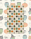 Happy Halloween Kitchen & Tea Towel with Halloween faces like witches, black cats, pumpkins and skulls on cream