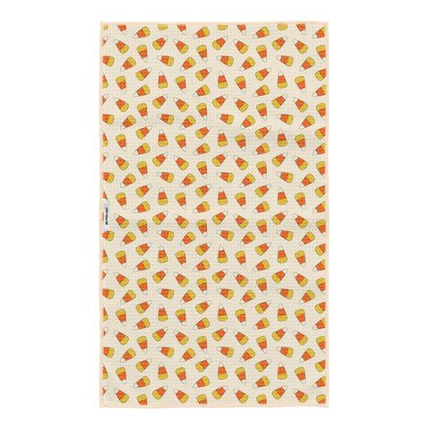 Reverse side of Happy Halloween tea towel with orange and yellow candy corn pattern on cream, with Trek Light tag