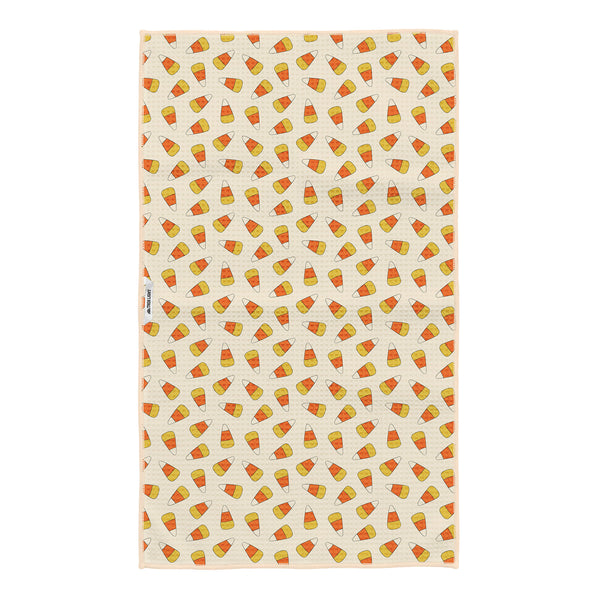 Reverse side of Happy Halloween tea towel with orange and yellow candy corn pattern on cream, with Trek Light tag