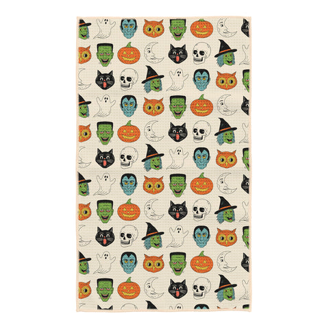 Cream Happy Halloween kitchen tea towel with vintage witches, Frankensteins, ghosts, black cats, skulls, owls, moons and