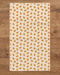 Happy Halloween waffle kitchen tea towel reverse side laid flat: candy-corn stripes on cream
