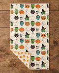 Happy Halloween waffle kitchen tea towel flat lay with a corner folded up to reveal the reverse print