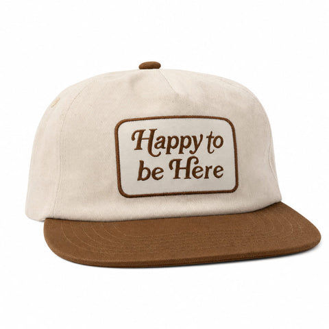 Happy To Be Here Hat featuring a beige cap with brown brim and embroidered text.
