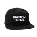 Black "Happy To Be Here" hat by Trek Light, showcasing positive vibes and casual wear.