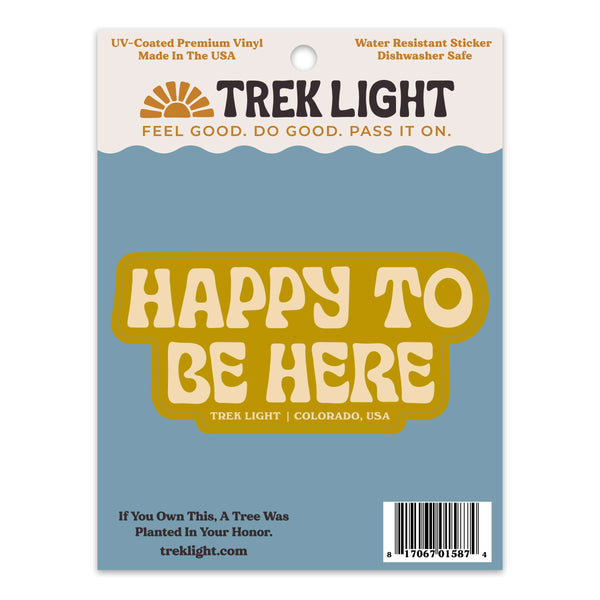 Happy To Be Here sticker on blue backing, UV protected, waterproof, and dishwasher safe. Made in USA, premium vinyl. By Trek Light.