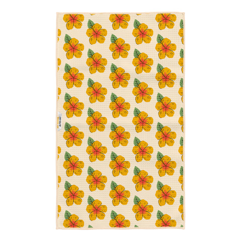 Reverse side of the Hawaii kitchen tea towel with a repeating yellow and orange hibiscus flower pattern on cream Grip-Tex